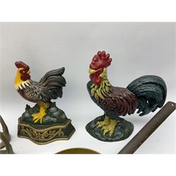 Two door stops in the form of cockerels, set of brass fire irons, horse bits, stirrups and other metal ware