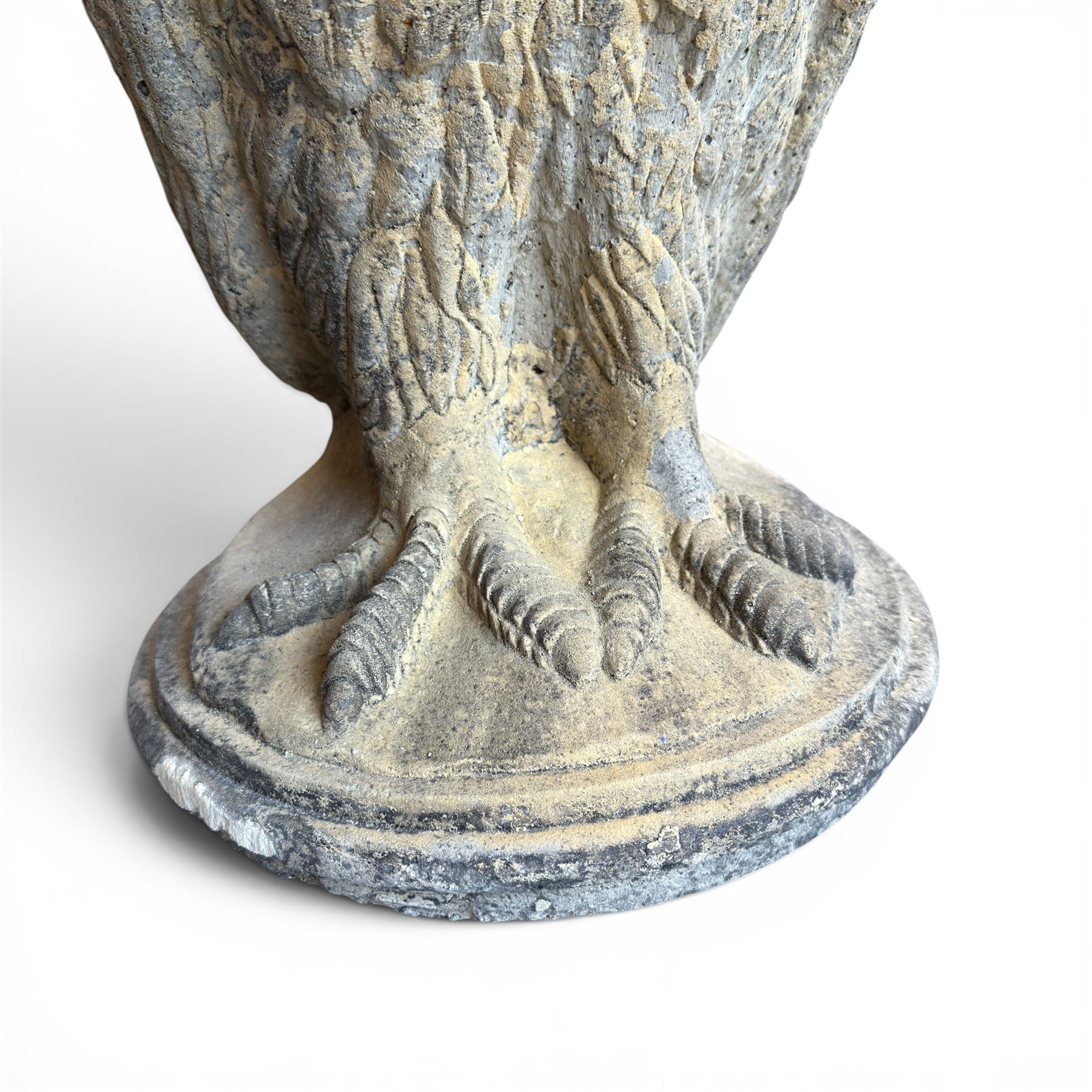 Pair of large composite stone garden statues modelled as standing horned owls, raised on circular bases