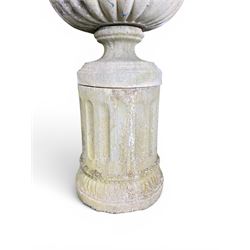Four 20th century good quality weathered cast stone pedestal urns, circular lobed bowls with rope twist and lattice border, raised on squat base with fluted columns