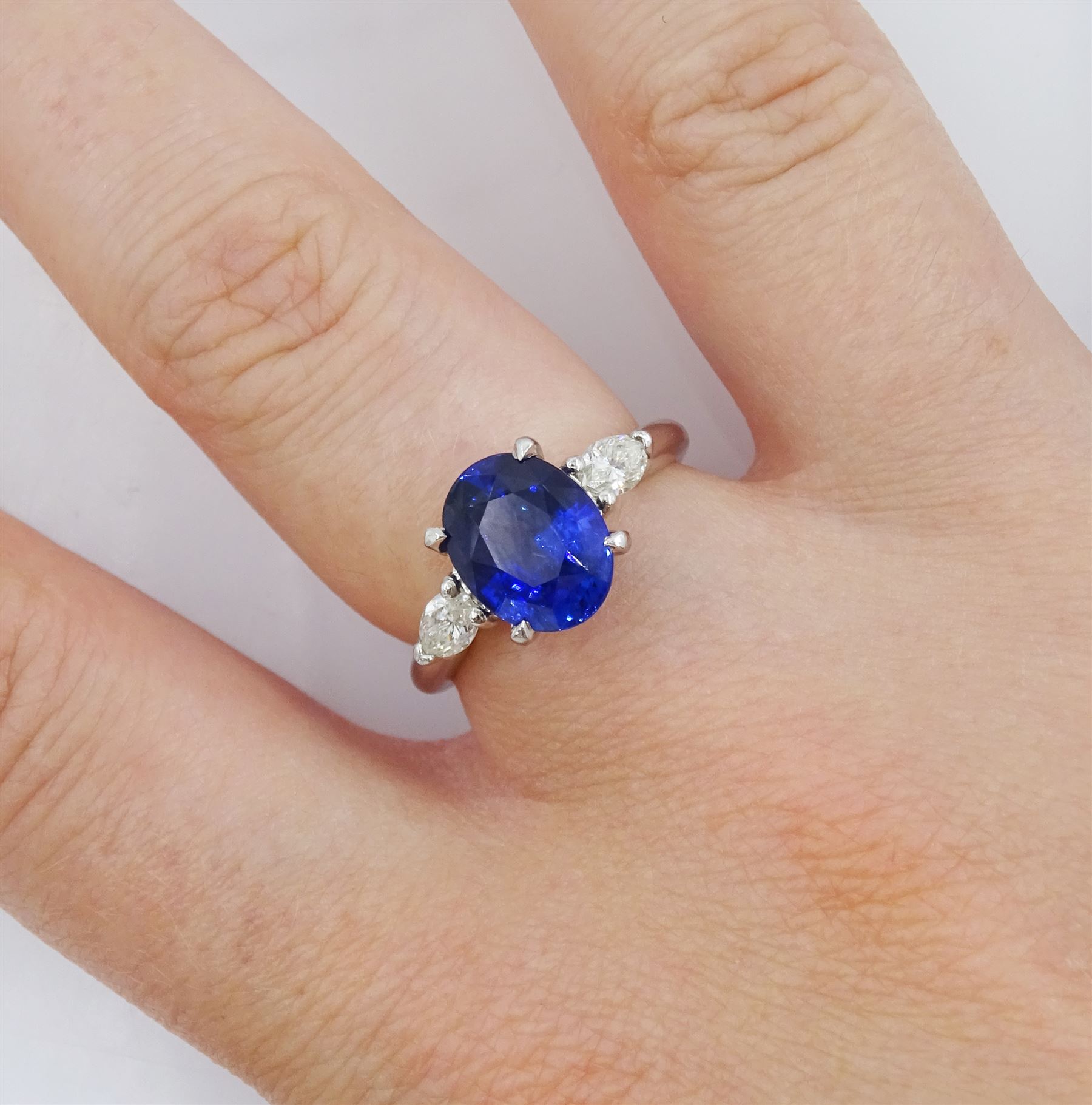 Platinum three stone oval cut sapphire and pear cut diamond ring, hallmarked, sapphire approx 2.70 carat