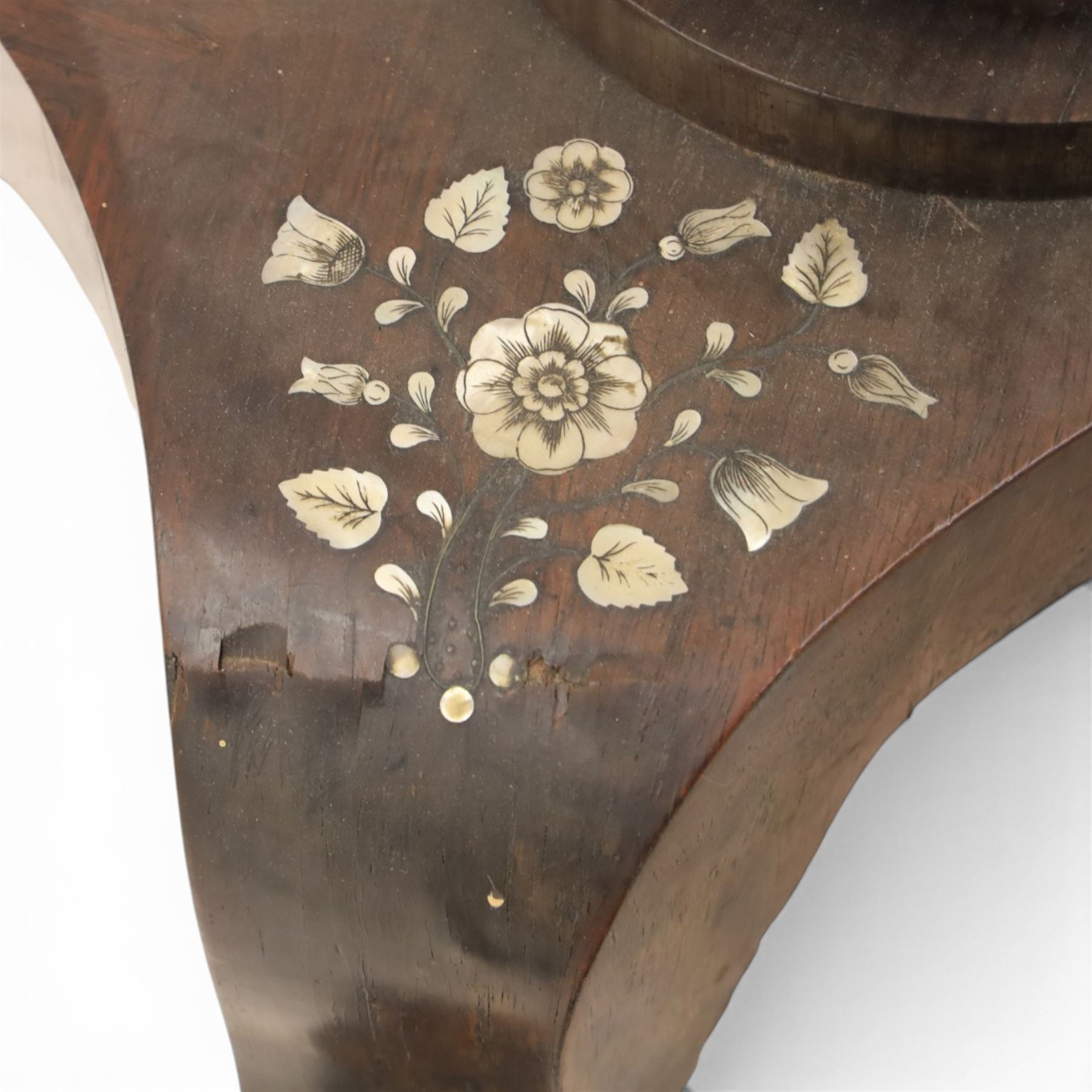 Victorian mahogany and mother-of-pearl inlaid work table, the octagonal hinged top enclosing a mirror and fitted compartmented interior, raised on a carved pedestal and quatriform platform base with scrolled feet