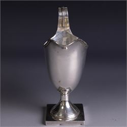 Edwardian silver helmet shaped cream jug, upon a square base, hallmarked John Rose, Birmingham 1905, together with a 1930s silver christening mug with engraved initials to body, hallmarked Aaron Lufkin Dennison, Birmingham 1936, jug including handle H13cm