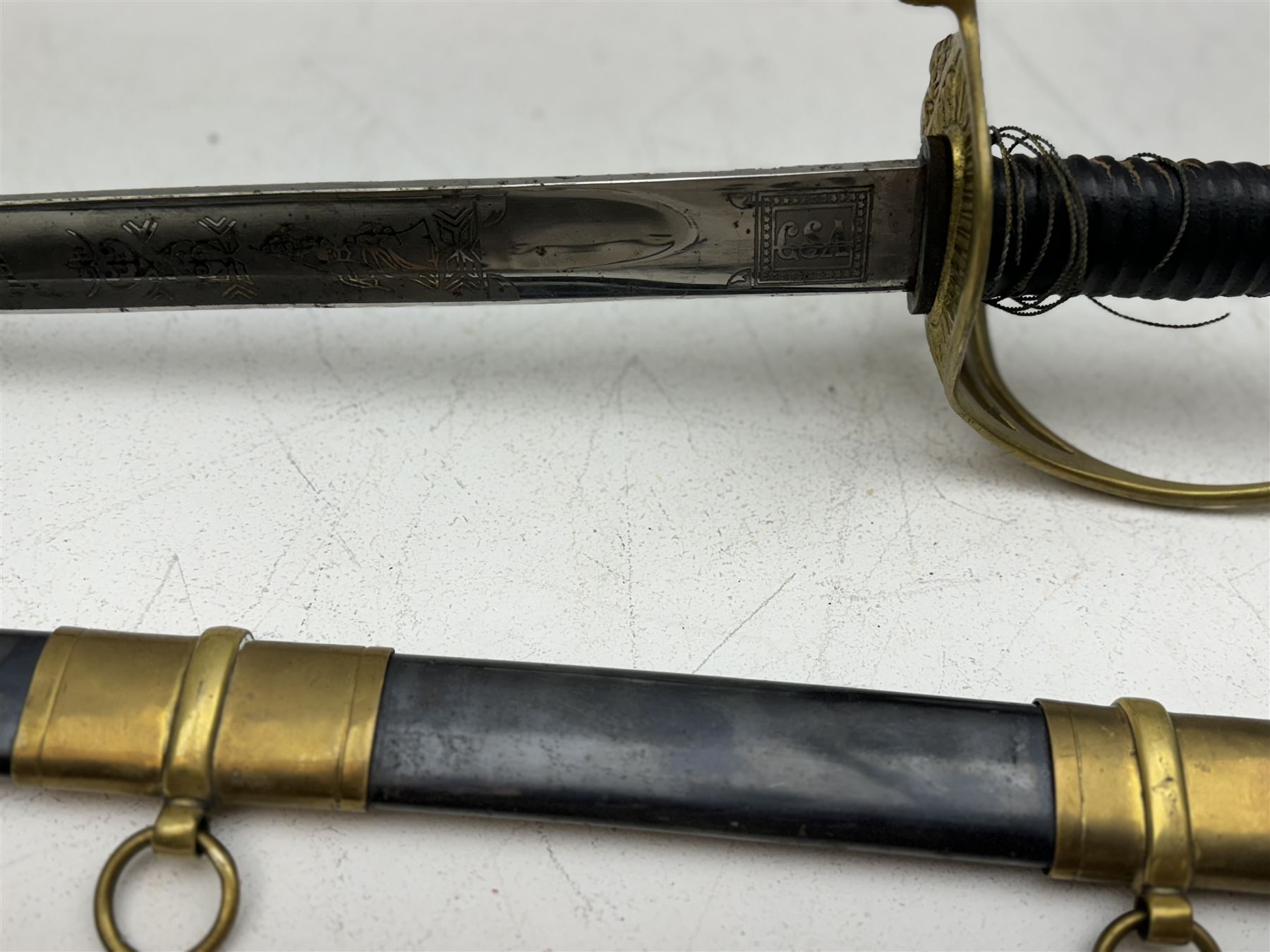 Replica Confederate States Army officer's sword, with brass pommel, black leather hand grip, the 85cm single edged blade marked CSA, in a metal and brass scabbard, L106cm