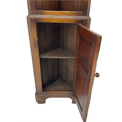 Narrow 20th century distressed oak corner cupboard, fitted with two open shelves above single cupboard