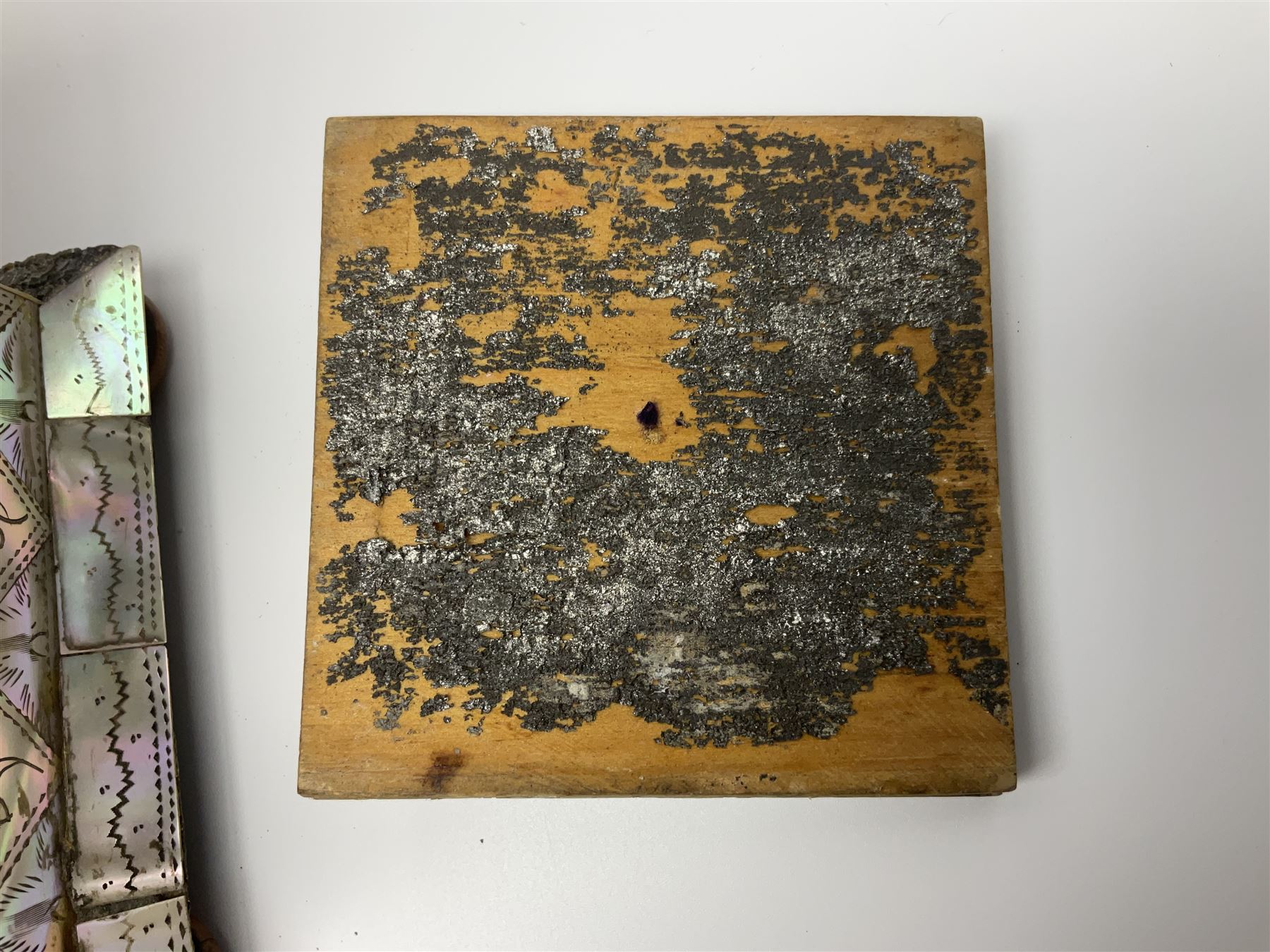 Victorian mother of pearl tea caddy, of rectangular bow-fronted form, the body with floral, bird and geometric engraved mother of pearl panels, white metal shield plaque to the cover inscribed with the initials G.J.A and similar escutcheon, the two division interior with ivory edging and two panelled mother of pearl lids, on four vegetable ivory bun feet L20cm, together with a similar style mother of pearl card case (2) This item has been registered for sale under Section 10 of the APHA Ivory Act