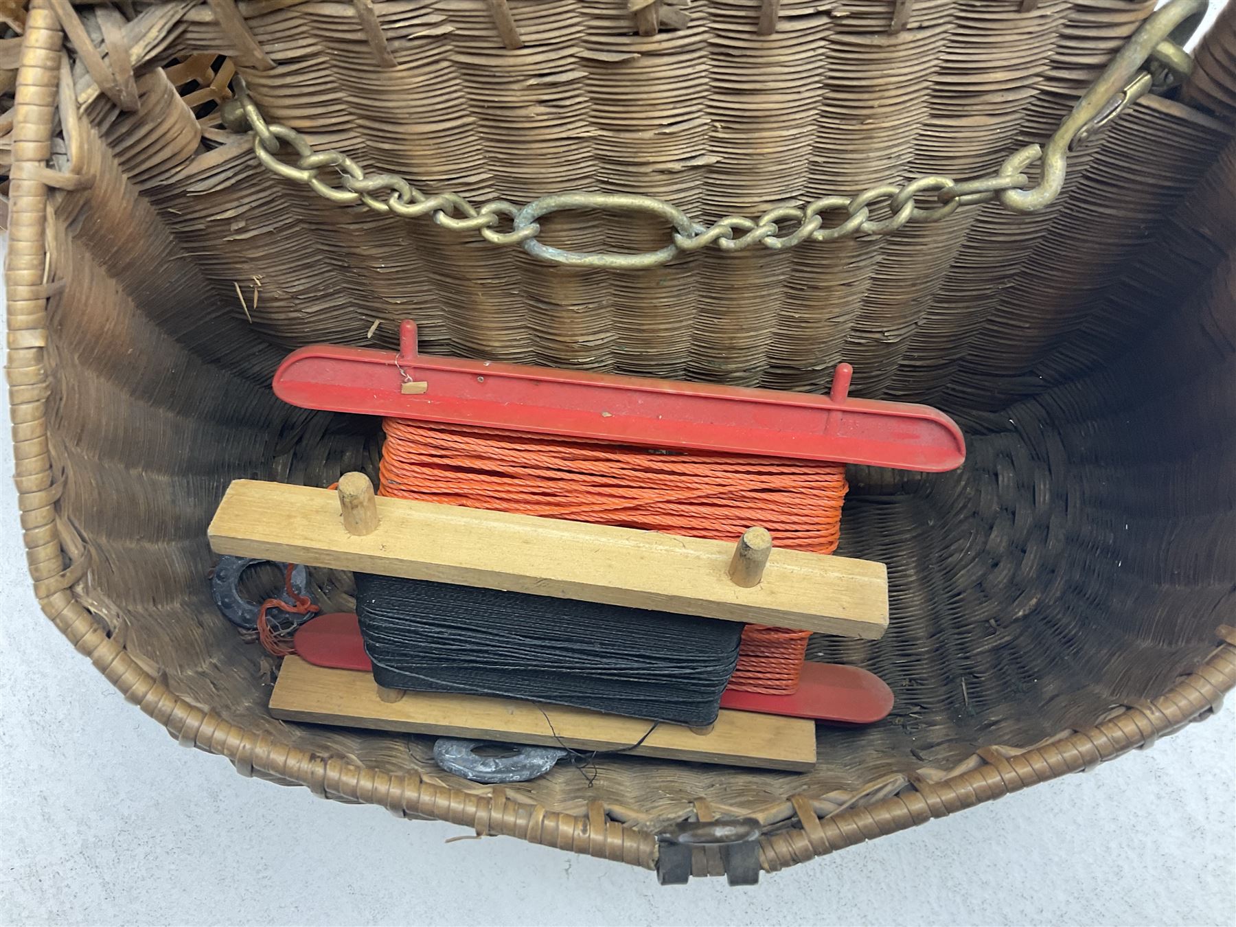 Fishing tackle and accessories housed in two wicker creels, including a landing net, fly tin, small brass reel, other reels to include two Intrepid Boy'o examples, crab lines etc 