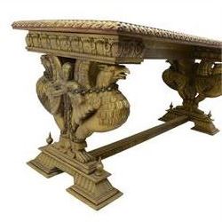 19th century Renaissance Revival carved and giltwood centre table, the rectangular top with gadrooned edge and carved frieze of repeating arched motifs with stylised scrolls, supported by a pair of carved winged griffin supports restrained by a central chained figure, on stepped rectangular bases united by carved stretcher