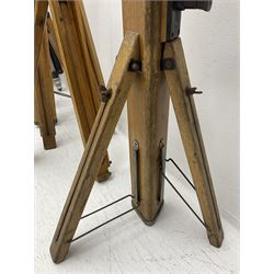 Three wooden adjustable tripods for plate cameras, together with a Linhof of Munchen metal tripod in a canvas case 