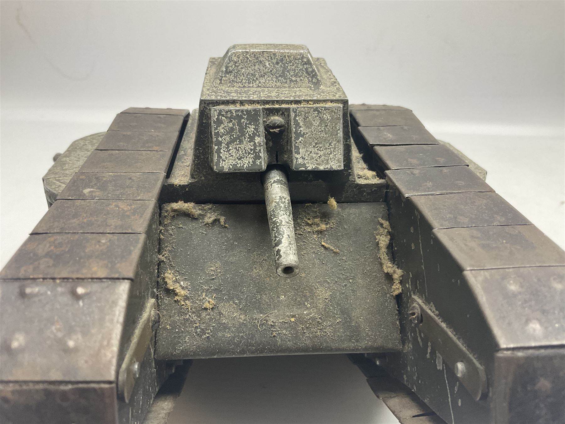 Large clockwork model of a WW1 Tank made of tin-plate and aluminium, with moving side cannons, the clockwork chain driven movement driving the articulated tin tracks; L28.5cms  W16.5cms and H13.5cms