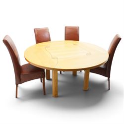 Contemporary round dining table and four orange faux leather chairs