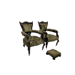 Pair late 19th century mahogany salon armchairs, scrolled cresting rail with cartouche design, carved and pierced back support, upholstered in patterned olive green fabric with sprung seat, on cabriole supports with ceramic castors; with matching footstall