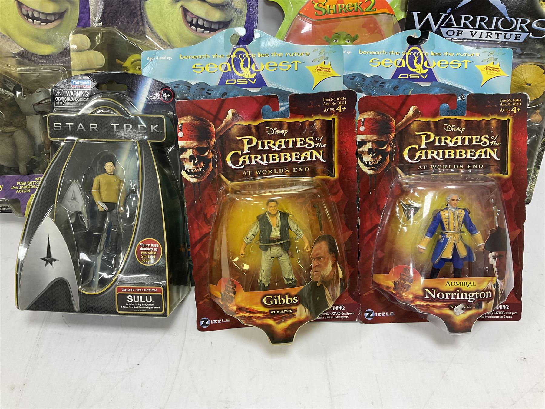 Seventeen TV & film related carded action figures comprising four Pirates of the Caribbean; five Shrek; three Star Trek; two Sea Quest DSV; Captain Scarlet, Warriors of Virtue; and Jurassic World; all in unopened blister packs (17)