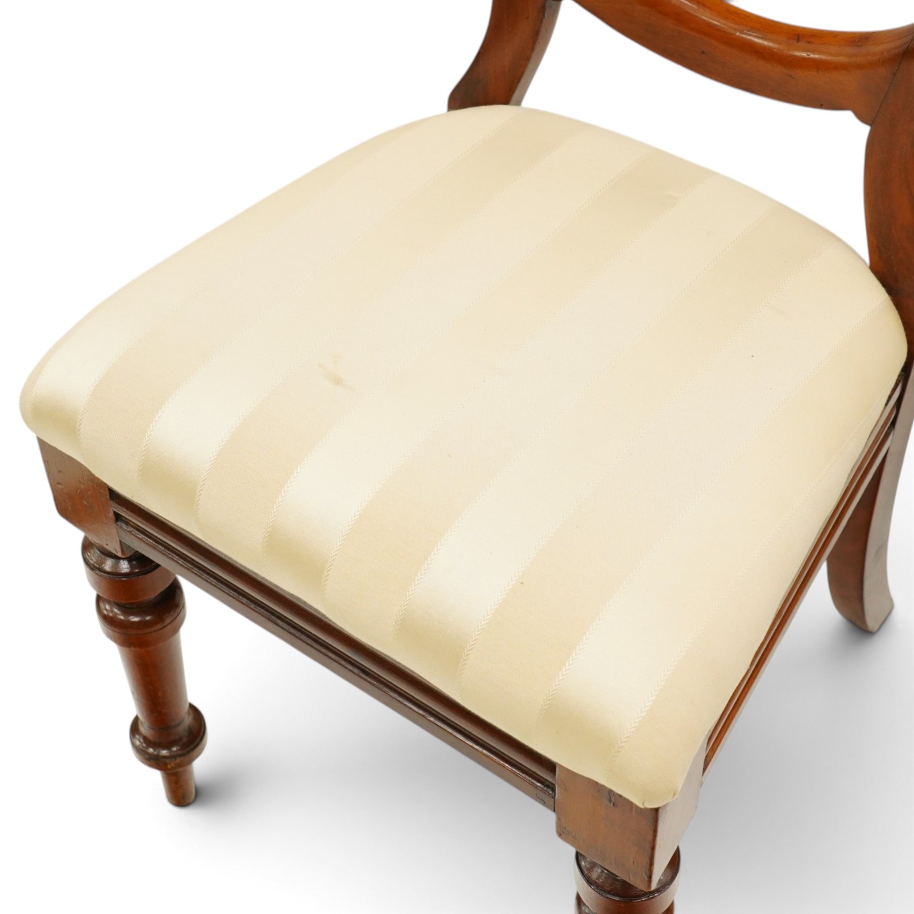 Set of twelve Victorian walnut balloon-back dining chairs, shaped open back over seats upholstered in striped ivory fabric, moulded seat rail above turned and tapering suppors