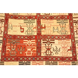  An Afghan hand woven silk rug, the oblong centre divided into twelve wide bordered rectangular panels each depicting stylised animals, birds and geometric motifs on an ivory or pink ground, within conforming borders in reds, black, pink, blue and ivory W118cm L202cm Provenance: This lot was gifted to the vendor who worked for the Royal Family of Oman  