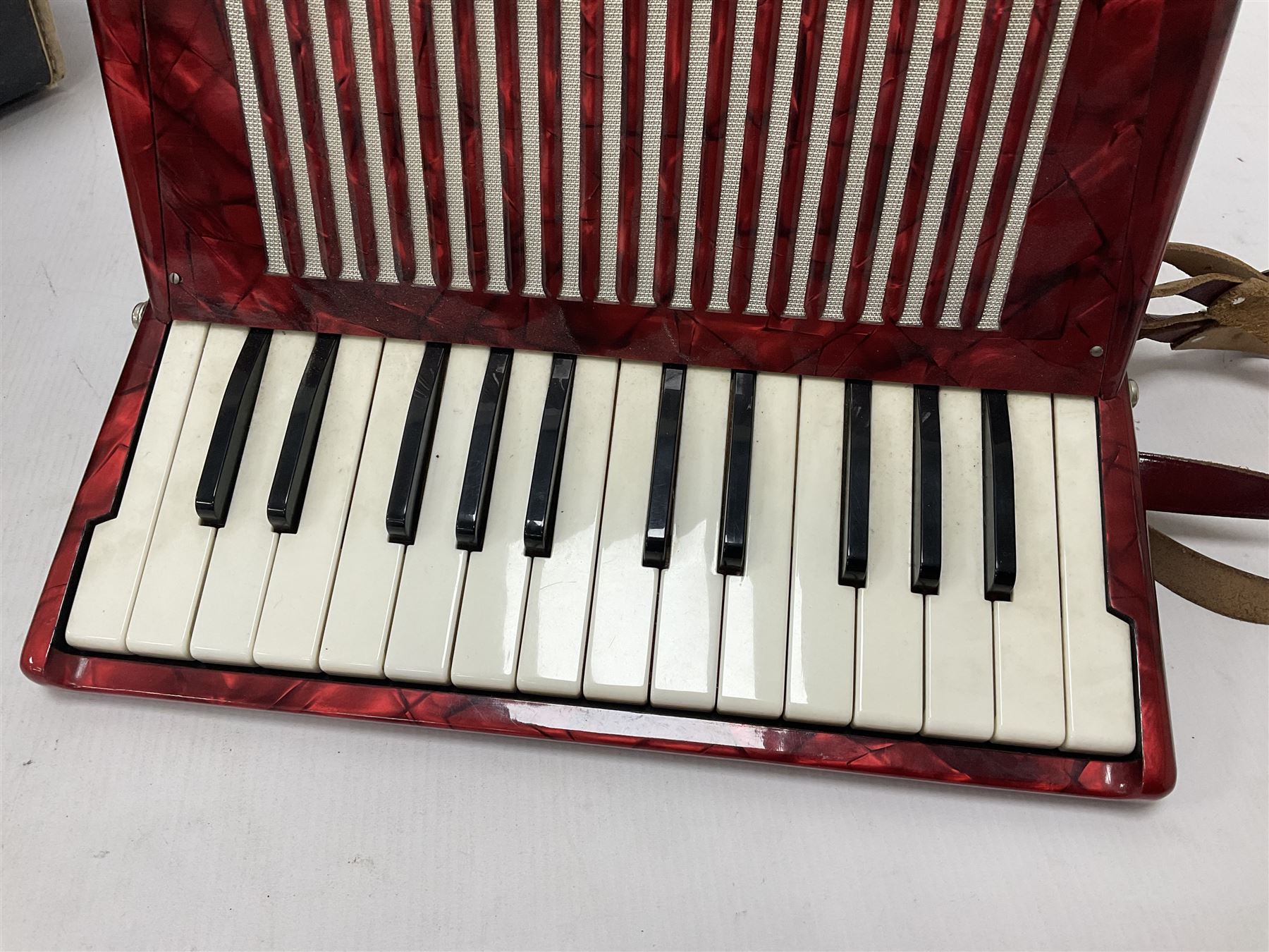 German Hohner student II compact accordion with 26 keys and 12 bass registers in a hard case With tutor