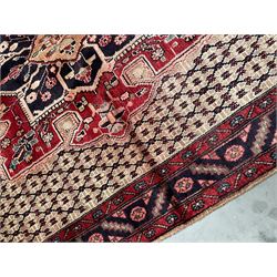 Persian Hamadan rug, pale brown ground field with central floral medallion and matching spandrels, repeating geometric design guarded border