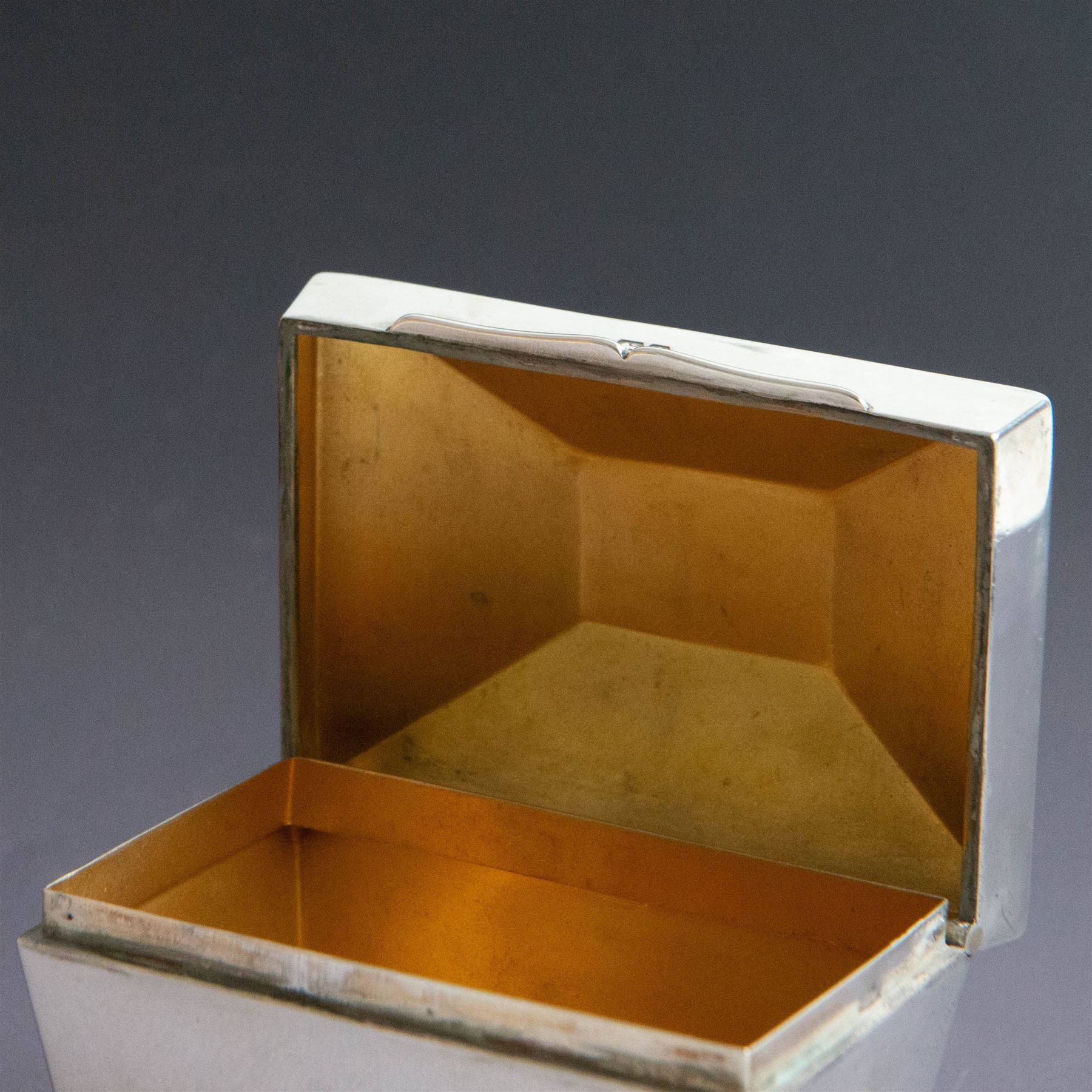 Early 20th century silver tea caddy, of sarcophagus form with twin lion mask mounted loop handles, upon four bun feet, hallmarked William Hutton & Sons Ltd, Birmingham 1913, H8cm, W9cm