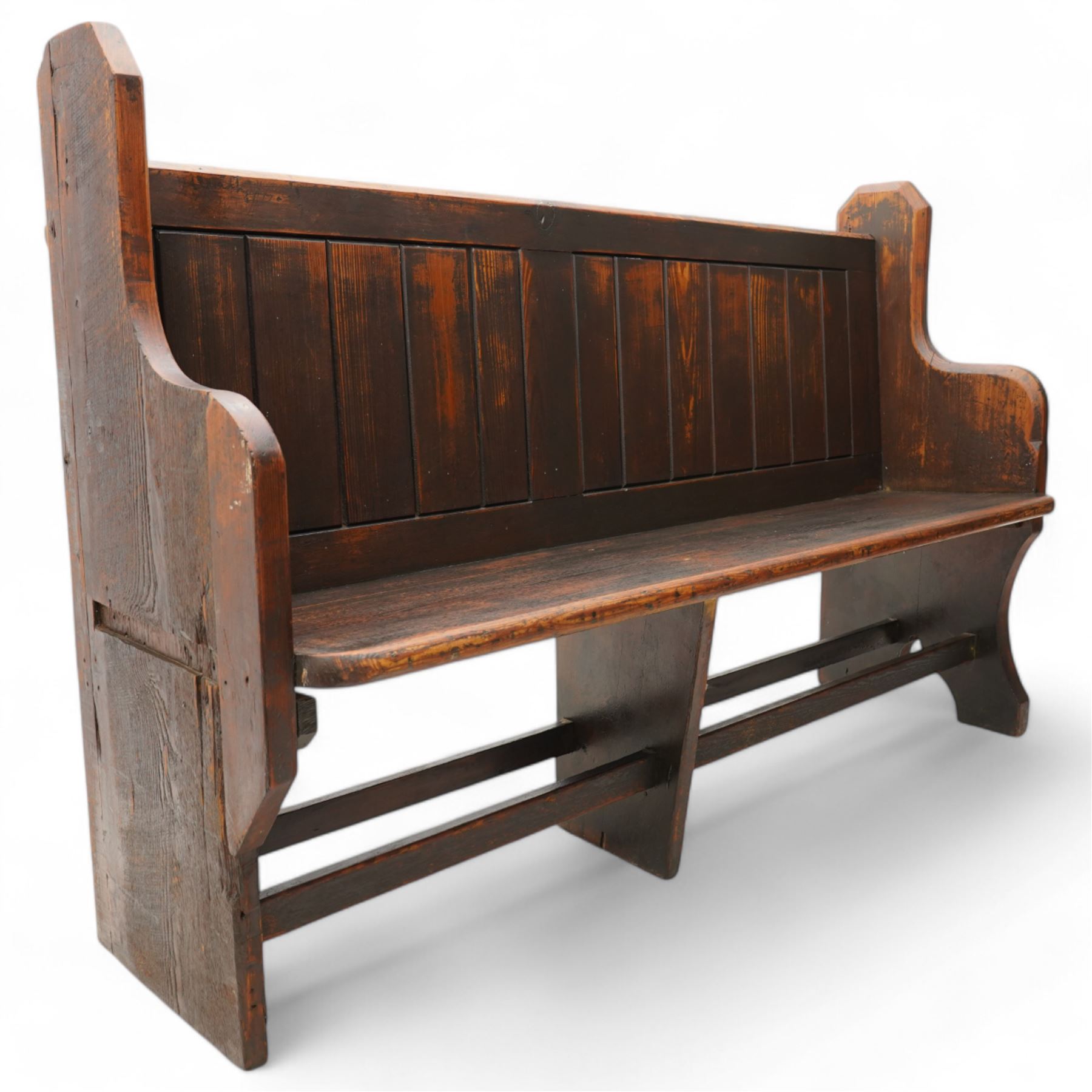 Victorian pine pew or bench, panelled back with book raised over plank seat, on shaped end supports united by stretcher 