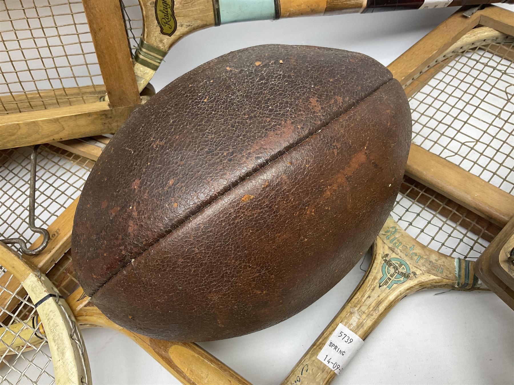 Quantity of early 20th century and later tennis rackets, to include Artus Majesty, Dunlop Alpha, Atlas Silver Shield and Raleigh Konni, together with a stitched rugby ball