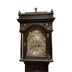 Edward Golland of Retford (Notts) - mid-18th century 8-day carved oak longcase c1760 , with a stepped caddy top and blind fret, break arch hood door flanked by carved pilasters with brass capitals,  trunk with a carved break arch toped door on a carved plinth with applied skirting and feet, brass dial with matching steel hands, silvered and engraved dial centre and chapter ring, with seconds dial and calendar aperture, four seasons spandrels and boss to the arch with makers name, four pillar rack striking movement, striking the hours on a bell. With weights and pendulum.            
Edward Golland is recorded as working in Retford during the late 18th century.