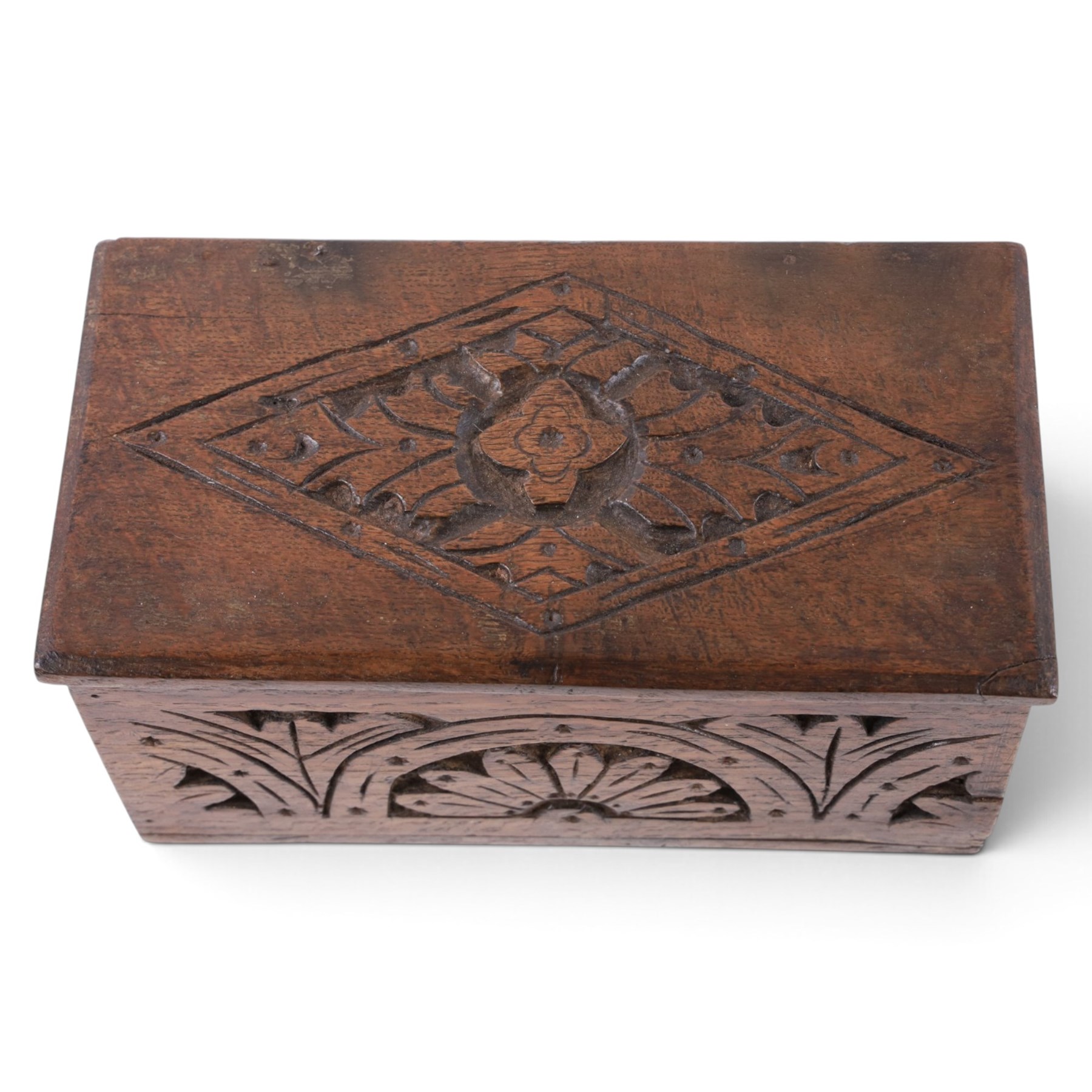 Carved oak box, the hinged lid with a carved diamond motif, the sides and front carved with stylised flowers, H12cm, L24cm