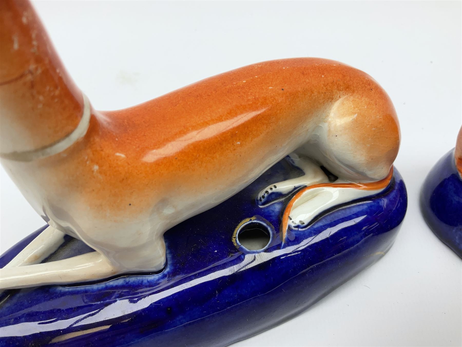 Pair of Staffordshire recumbent greyhound pen holders 