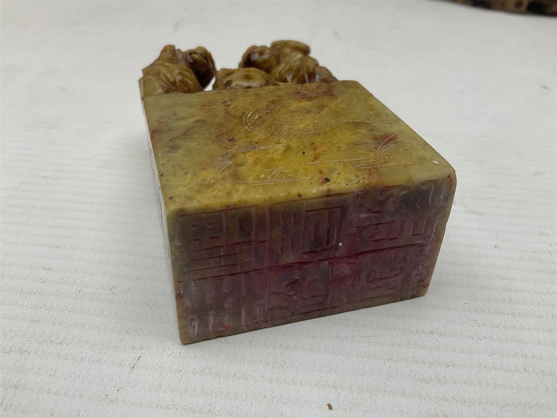 Collection of hardstone and soapstone, including hardstone seal carved temple dogs finial, inscription on base, together with inkwells, vases etc  