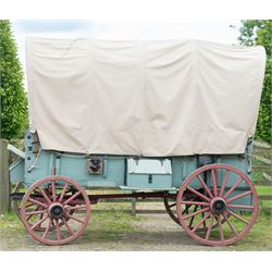 Western Covered Chuck Wagon

A large four wheeled covered wagon of timber construction, painted pale green with red painted wooden spoked wheels and a cream canvas tilt over an arched frame. The wagon has a traditional box body with covered rear compartment, front driving position, underbody turntable steering and iron fittings throughout. Fitted with external equipment details including a side mounted barrel, lidded storage chest, rope tie downs, horseshoe fittings and rear storage box.

Features

• Pale green painted timber body
• Cream canvas tilt over arched frame
• Covered rear compartment
• Front driving position
• Side mounted barrel
• External lidded storage chest
• Rear storage box
• Wooden spoked wheels
• Iron tyres
• Underbody turntable steering
• Rope tie downs
• Horseshoe fittings
• Iron hardware and brackets
• Brass restoration plaque to rear

Dimensions:
Overall length: 335 cm
Width: 170 cm
Height: 275 cm

Wheel Diameters:
Front wheels: 92 cm
Rear wheels: 112 cm

Seating:
Driver: 1
Passenger: Rear covered compartment