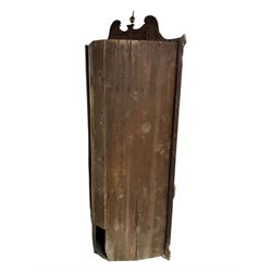 George III mahogany corner cabinet, the scrolled pediment surmounted by a brass finial and carved fretwork frieze, with fluted uprights flanking arched double doors over a painted interior fitted with shaped shelves, above a lower cupboard with twin panelled doors, on plinth base