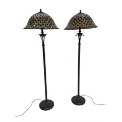 Pair ebonised metal standard lamps, reeded column wit scalloped base, with Tiffany design stained glass bell dome shaped shades