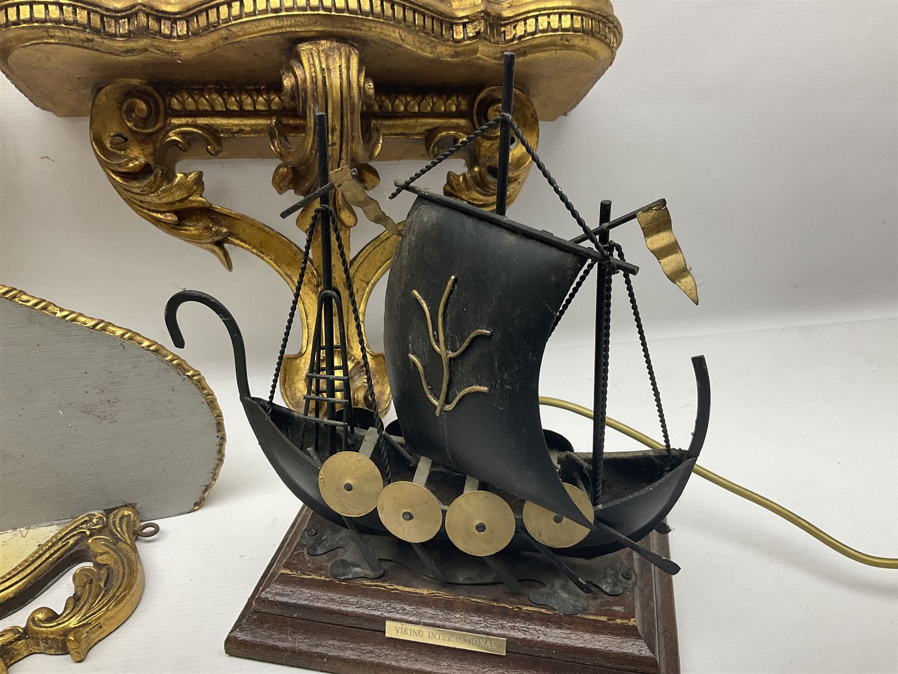 Five various giltwood and other hall brackets, one with marble top; and Viking ship table lamp