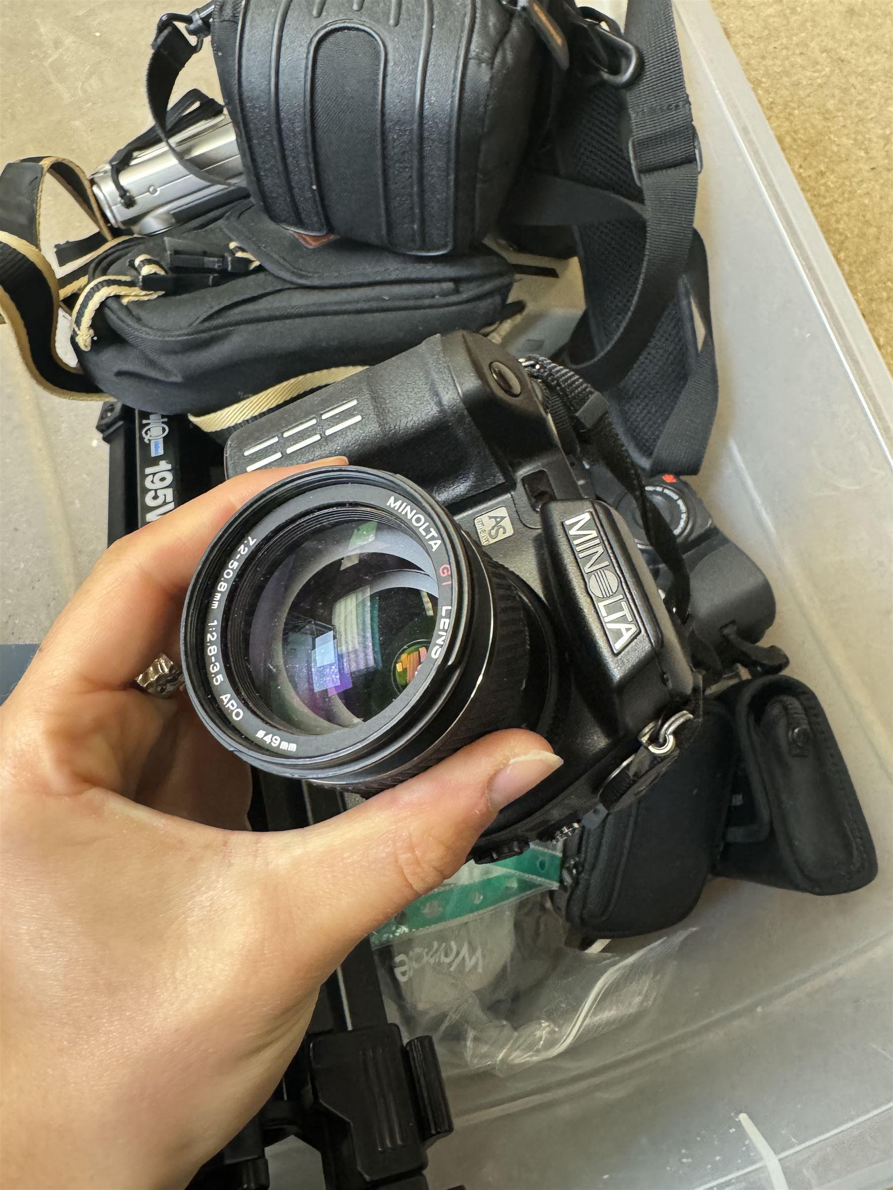 Collection of cameras and camera equipment, including Voigtlander Vitomatic I, Nikon Coolpix P340, Nikon Coolpix S9100, Olympus SP-510UZ, tripod, cases, etc