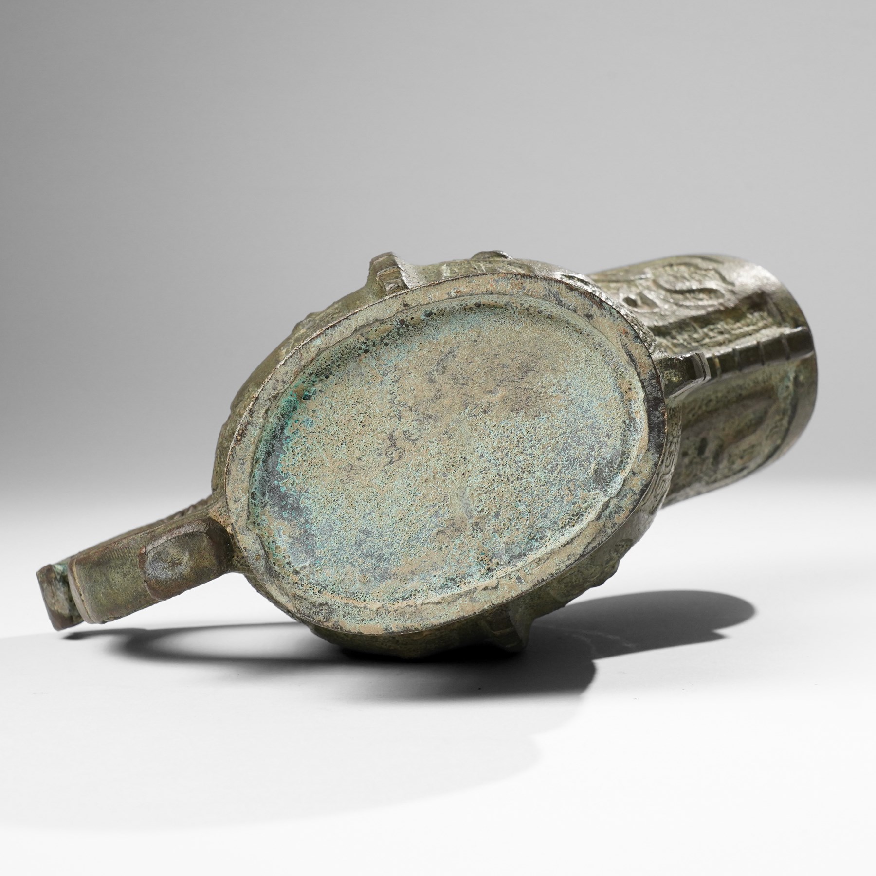 Chinese archaistic bronze wine vessel, Shang dynasty style but 20th century, W25cm; together with a Tang dynasty style model of a rearing horse, H17.5cm (2)