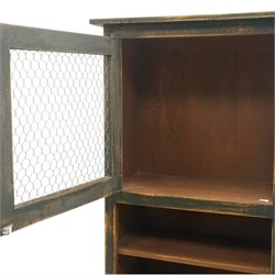 20th century pine kitchen cabinet in a green painted finish, top section with upper door with wire front above a recessed shelved area, the lower section with two drawers and twin wire fronted doors, raised on tapered supports