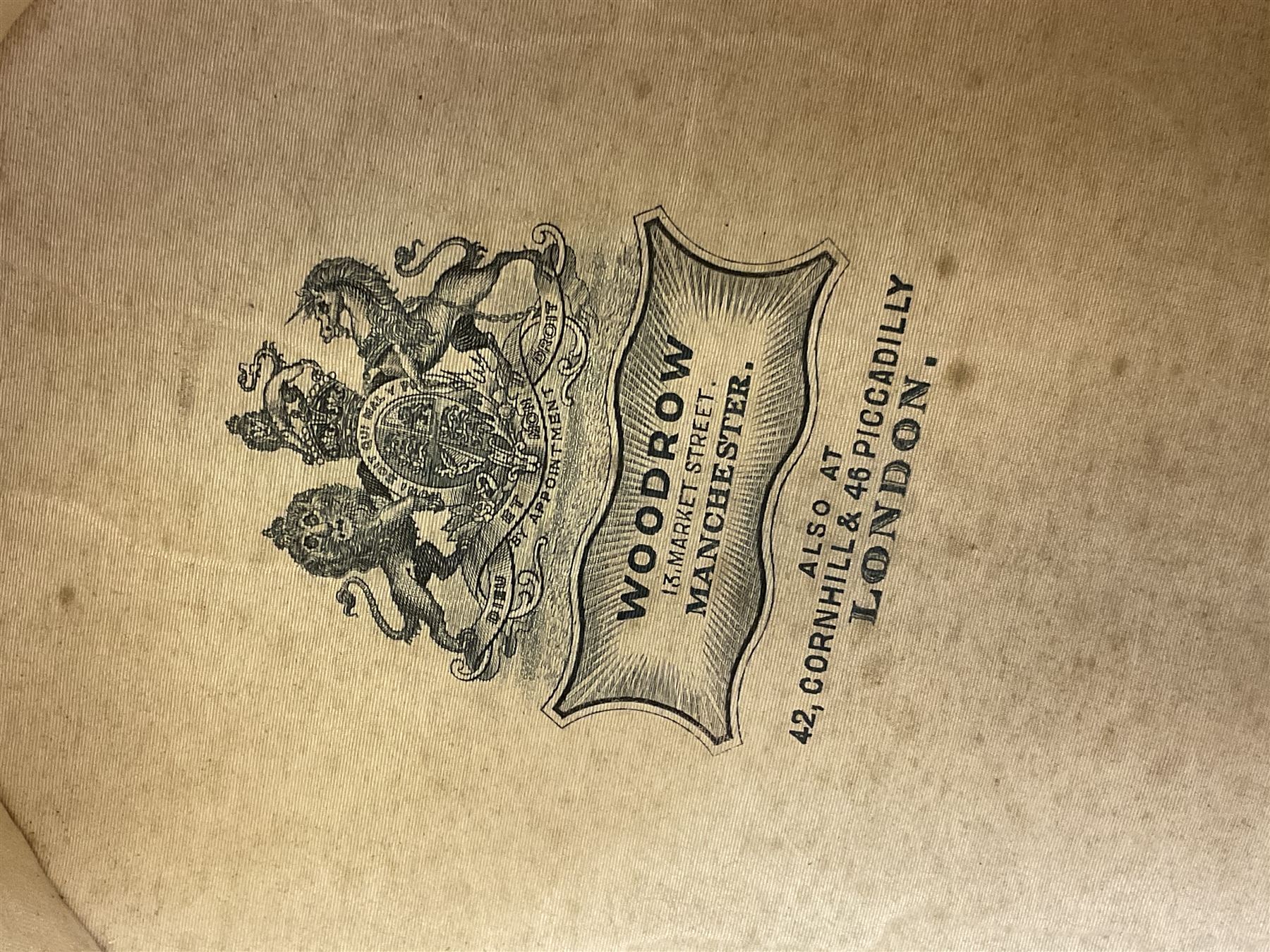 Early 20th century black silk top hat by Woodrow of Manchester and London, with manufacturer's stamp to the silk lined interior, housed in fitted tan leather hat box with removable internal compartments with straps, brass escutcheon and engraved plaque, hat internal measurements approx 20cm x 15cm