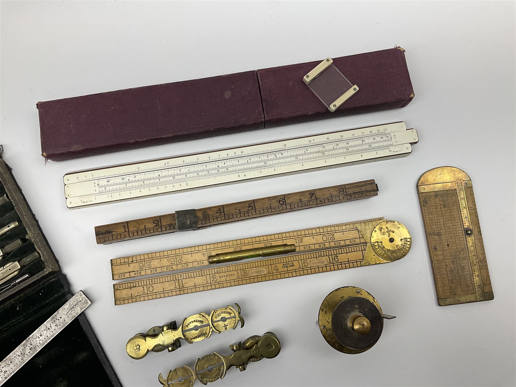 Two Victorian brass sovereign scales, one marked 'Harrison' L10cm; cased set of drawing instruments by G. Thornton Limited Manchester; Chesterman No.770/1 steel vernier caliper; two boxwood rulers; cased slide rule; brass and boxwood rope/wire gauge etc