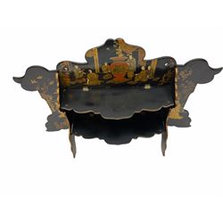 Late 19th/early 20th century black lacquered folding wall shelf or table stand, of shaped form, with two folding shelfs and two folding supports, decorated in the Chinoiserie style with figural scenes, H32cm W49cm
