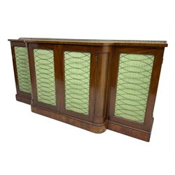 19th century mahogany break-front sideboard, raised brass gallery back with Greek key design, fitted with four cupboard doors, their pleated green fabric overlain with gilt metal grilles, lower moulded edge over plinth base
