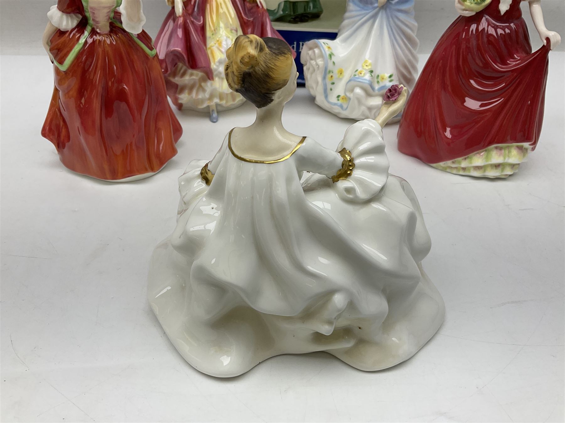 Five Royal Doulton figures, comprising Flower of Love HN3970, Emily HN3688, Southern Belle HN2229, Helen HN3886 and My Love HN2339, all with printed mark beneath, some with boxes, together with a Royal Doulton Figures reference book by D Eyles and R Dennis