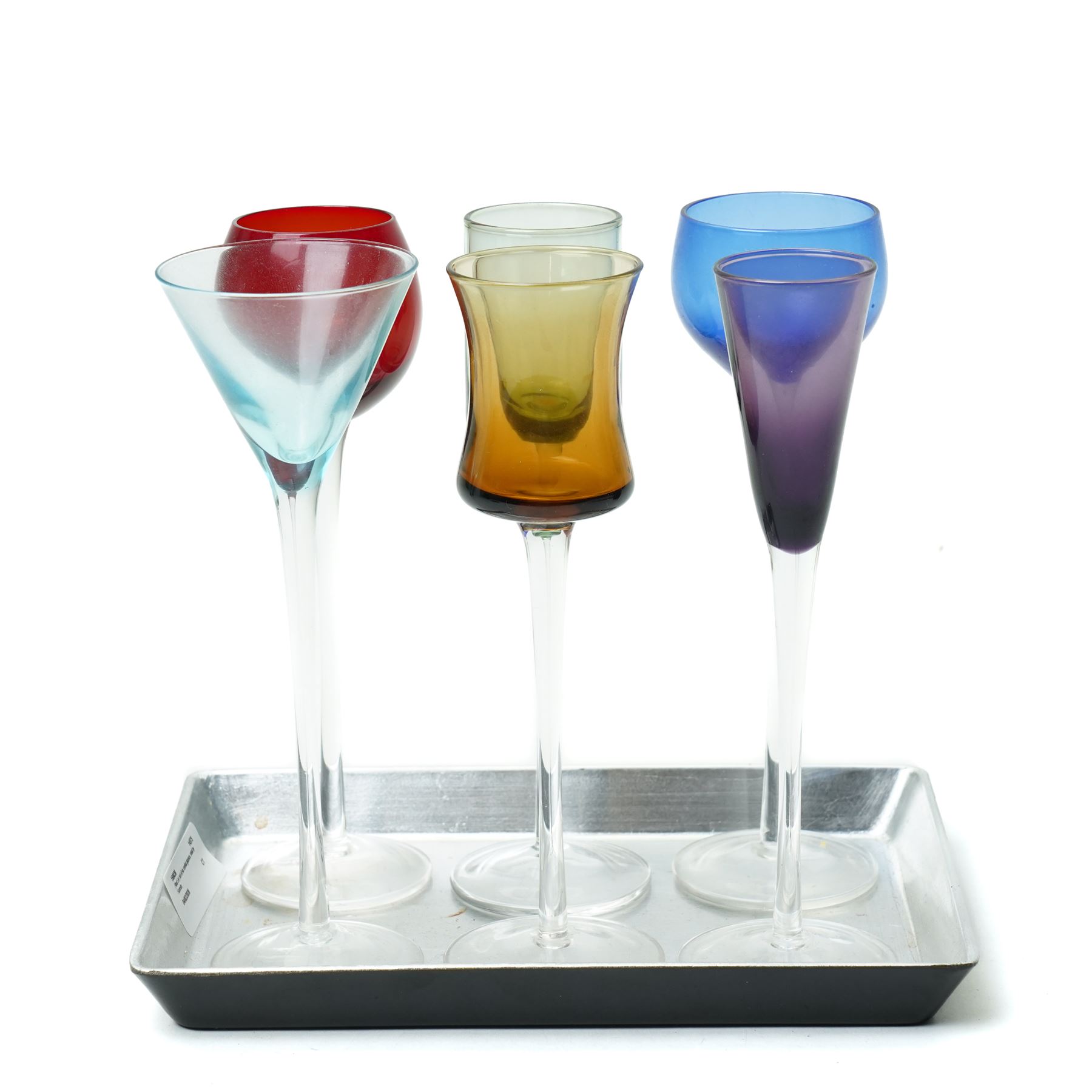   Six cordial glasses each with a different coloured bowl on slender stems understood to be retailed by Harrods on a small lacquered tray