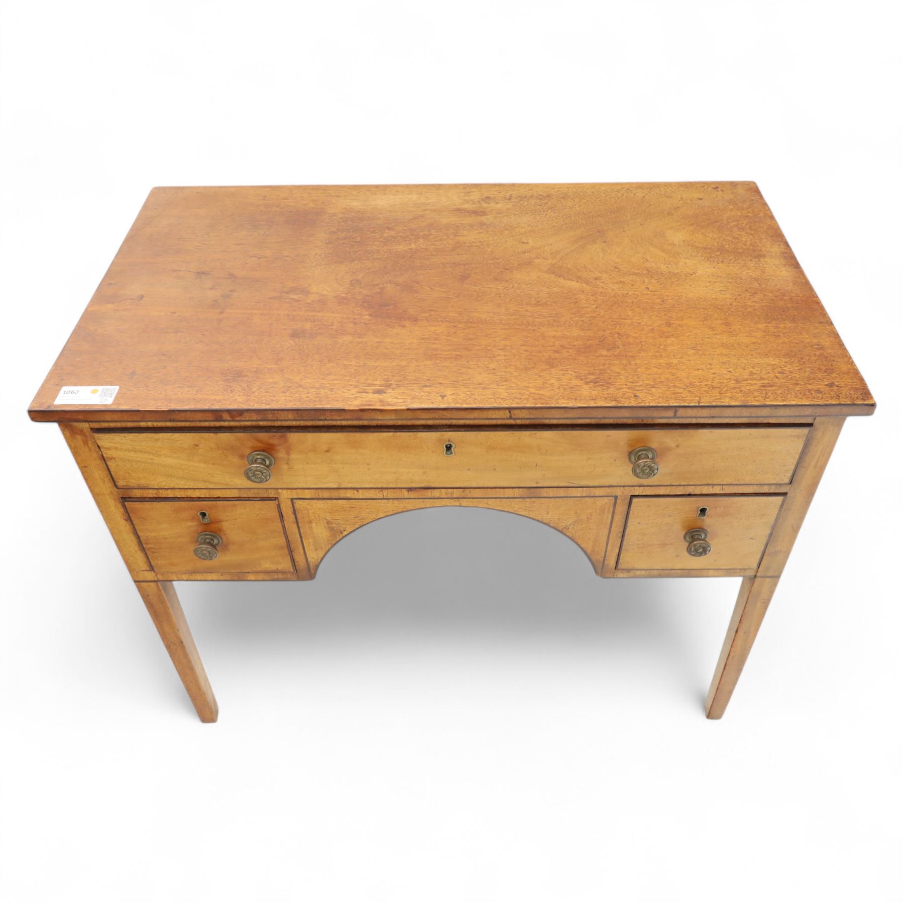 Early 19th-century mahogany kneehole desk with ebony stringing, rectangular top above an arrangement of one long and four short drawers, each with brass knob handles, raised on square tapered legs