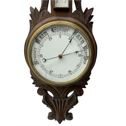A 1920s oak cased patented aneroid barometer with openwork decorative carving, 8” enamel dial recording air pressure from 26 to 32 inches with weather predictions in gothic script, steel indicating hand and brass recording hand within a brass bezel and flat glass (glass cracked), with a boxed mercury thermometer recording the temperature in degrees centigrade and Fahrenheit.    


