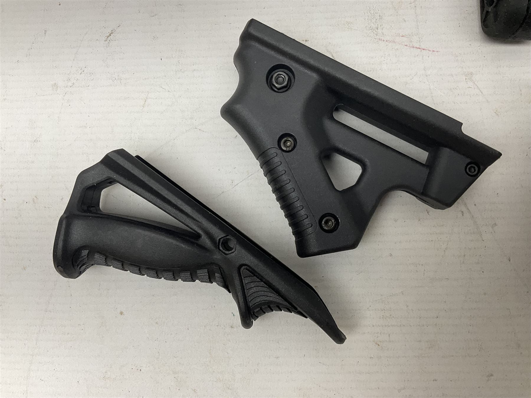 Assorted shooting accessories including two telescopic sights, red dot sight,  two bi-pods, spirit level mount, two gun butts and two forward handles