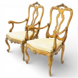 Pair of Italian carved walnut open armchairs, upholstered seats