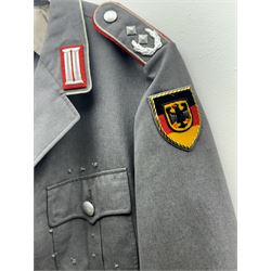 West German helmet steel helmet, together with 1960's peak cap and tunic with German insignias 