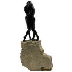 Composite sculpture embracing couple, after Joseph Bofill on a rocky base, height 33cm.
