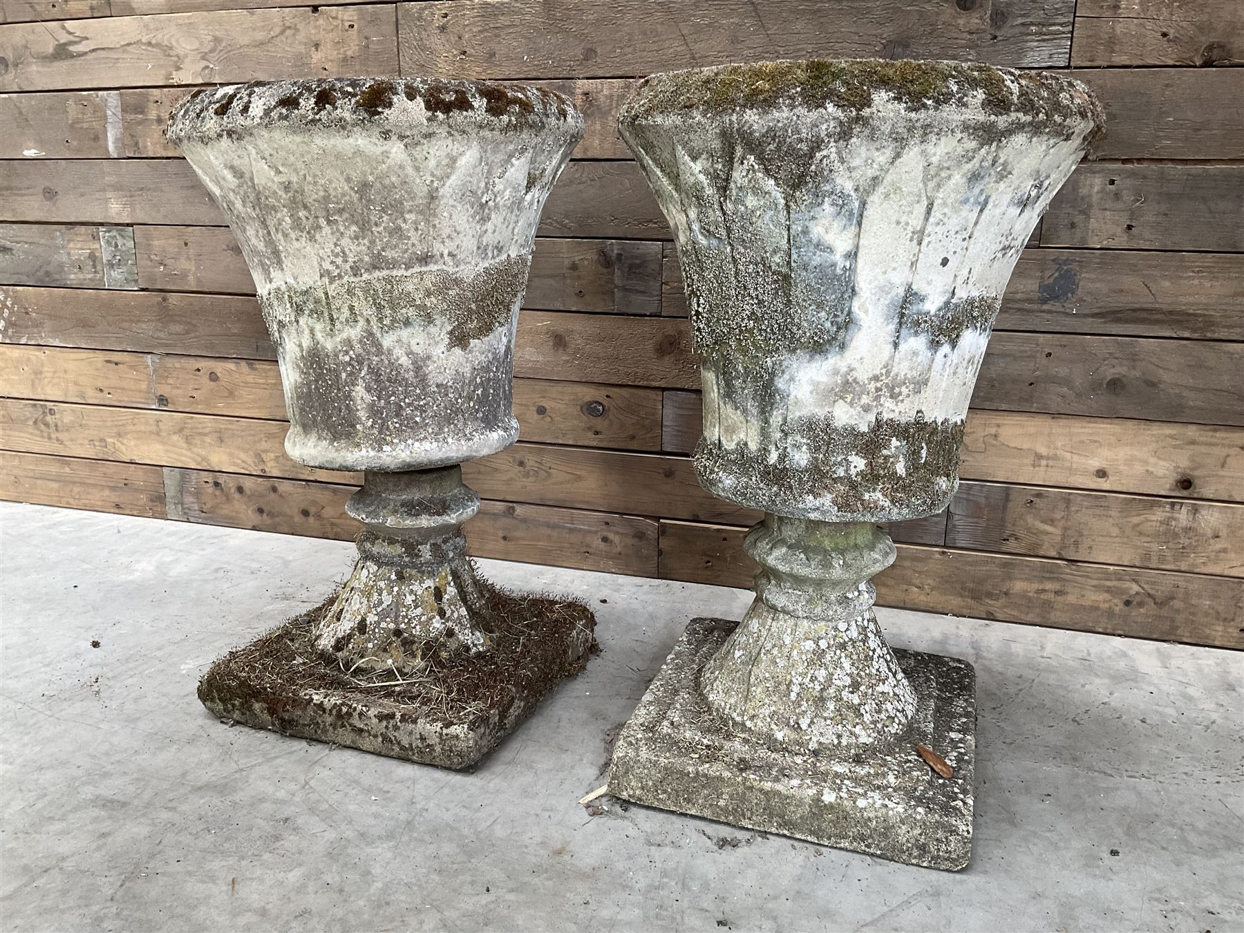 Pair of Regency design weathered cast stone garden urns