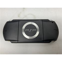 Sony PlayStation 3 60GB console with one PS3 controller, two PS2 controllers, BD remote control, PSP handheld gaming console with case, GAMEware PSP essentials pack, and a selection of PS2, PS3 and PSP games in original cases with instruction booklets 