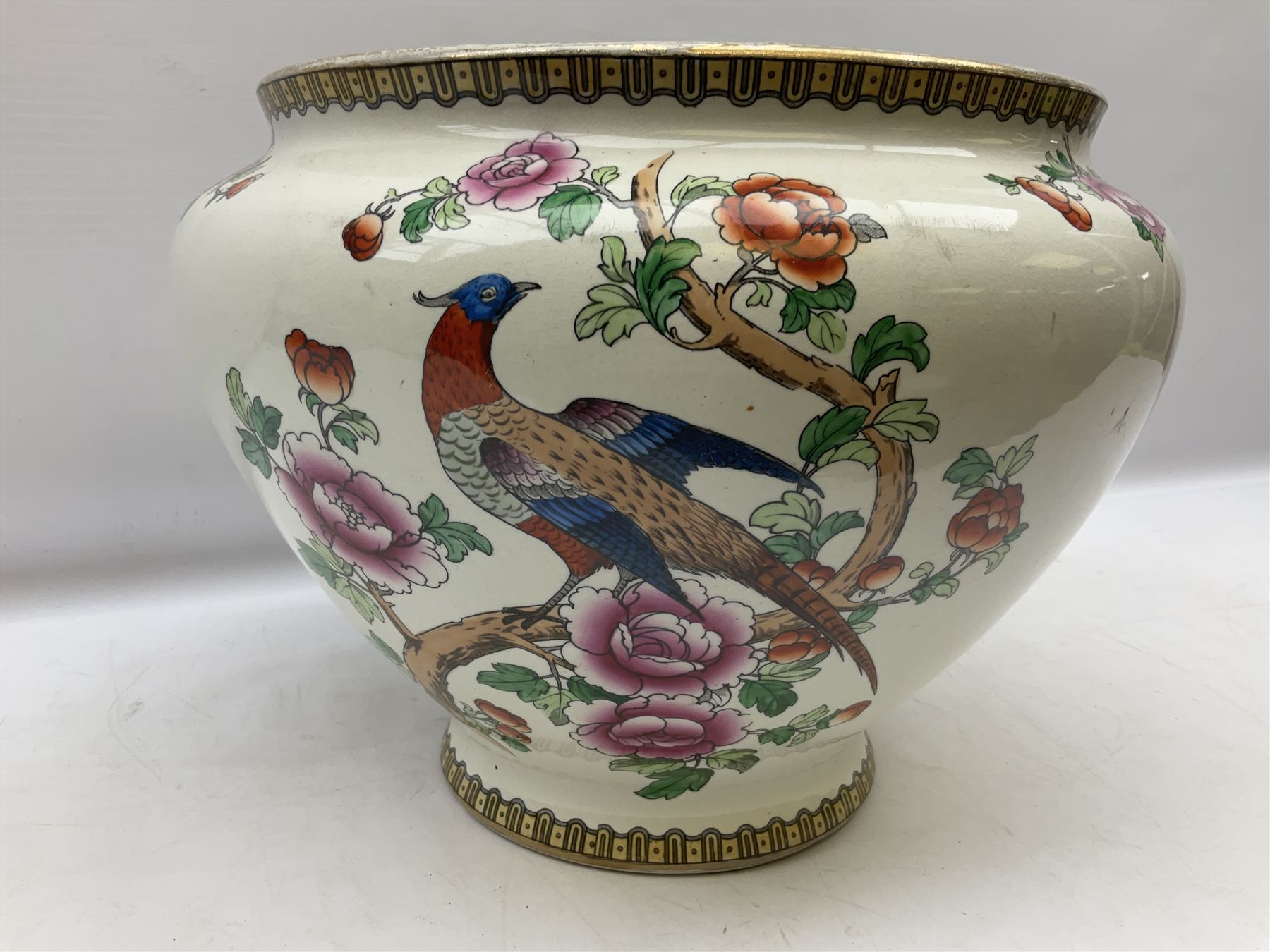 Large ceramic Jardiniere on stand, decorated with an oriental pheasant perched upon branches blossoming with peonies and foliage on white ground, overall H99cm
