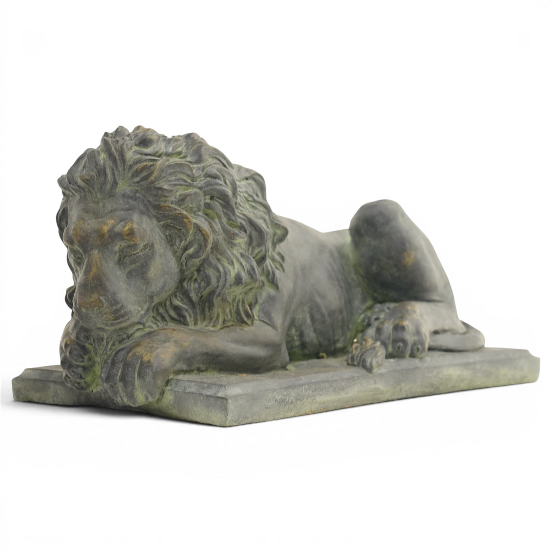 Pair of bronze effect lion figures, recumbent form with carved-style manes and outstretched forepaws, each on a rectangular base, with weathered green patinated finish